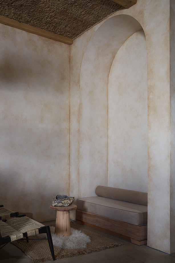 PALOMA arch nook with bench seating, crystal, and sheepskin rug