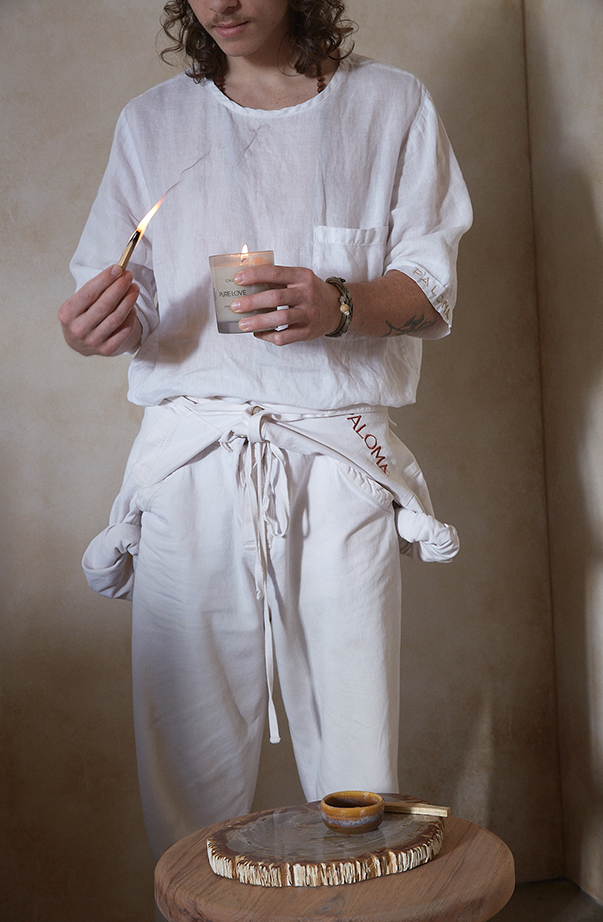 PALOMA team member in white linen uniform — the barefoot bohemian aesthetic in practice