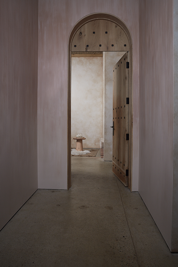 Arched wooden door opening into the PALOMA seating nook