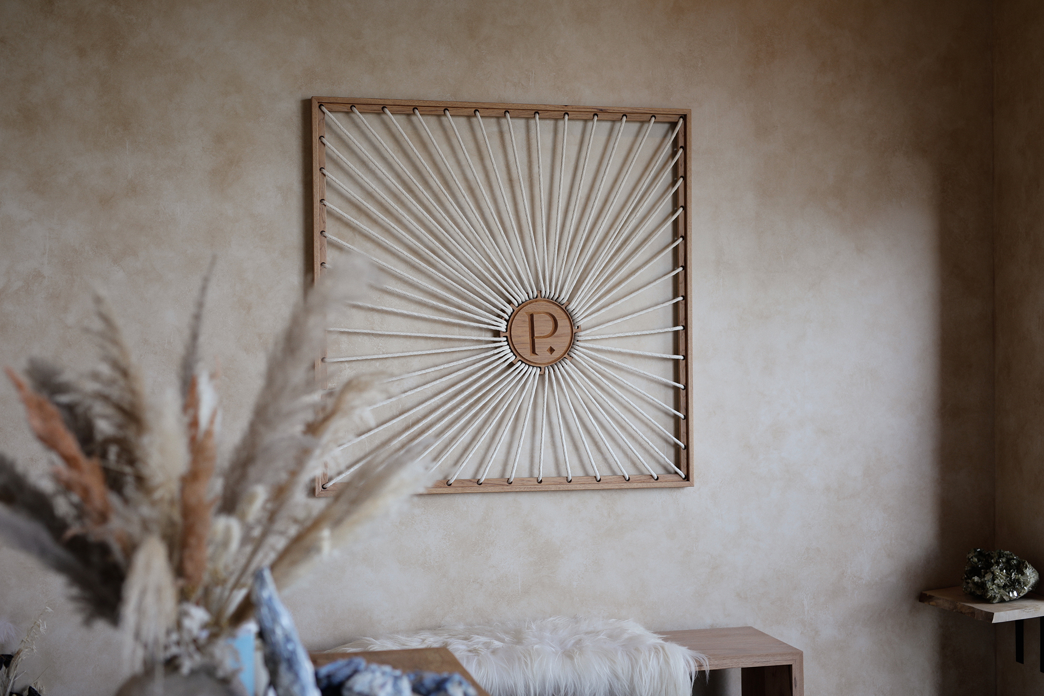 Close-up of the PALOMA Mind + Body sign on the terracotta facade