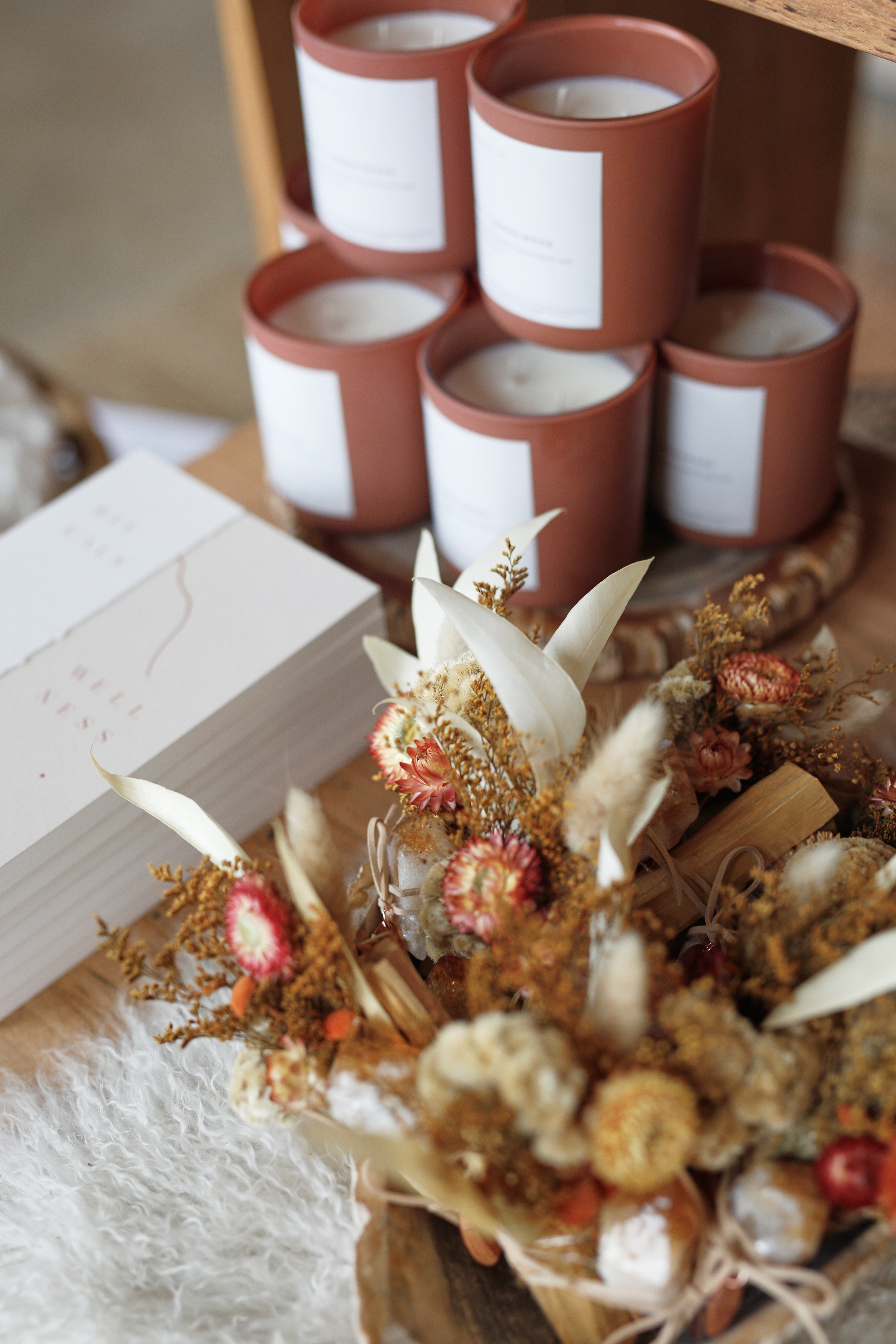 PALOMA retail display with branded candles, dried botanicals, and curated goods