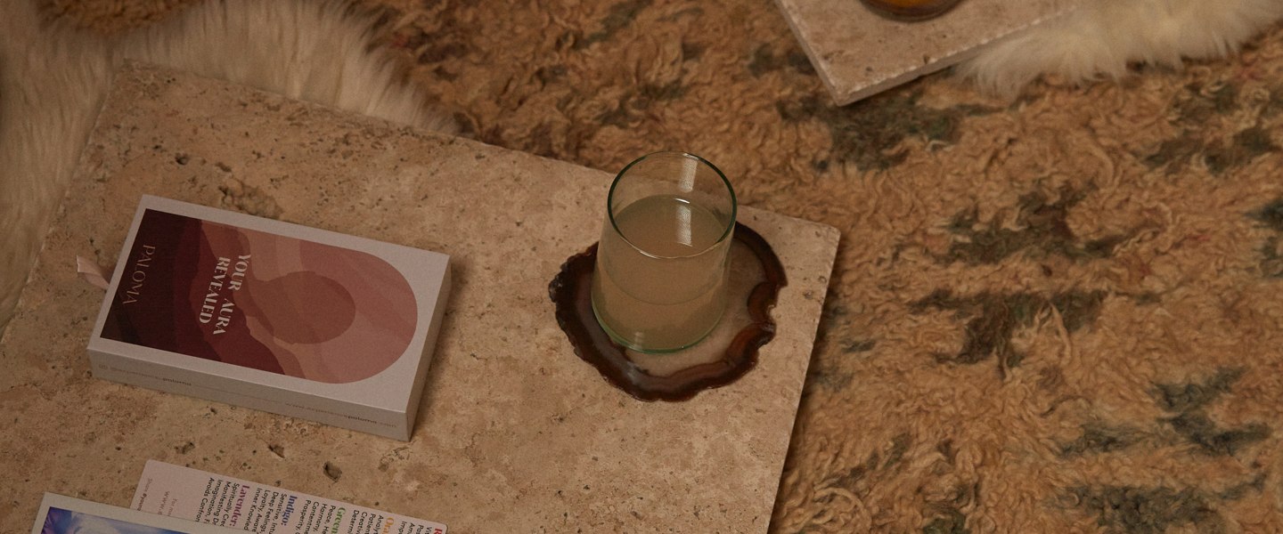 Oracle cards, a candle and a small dish set out on a sheepskin for a group session.